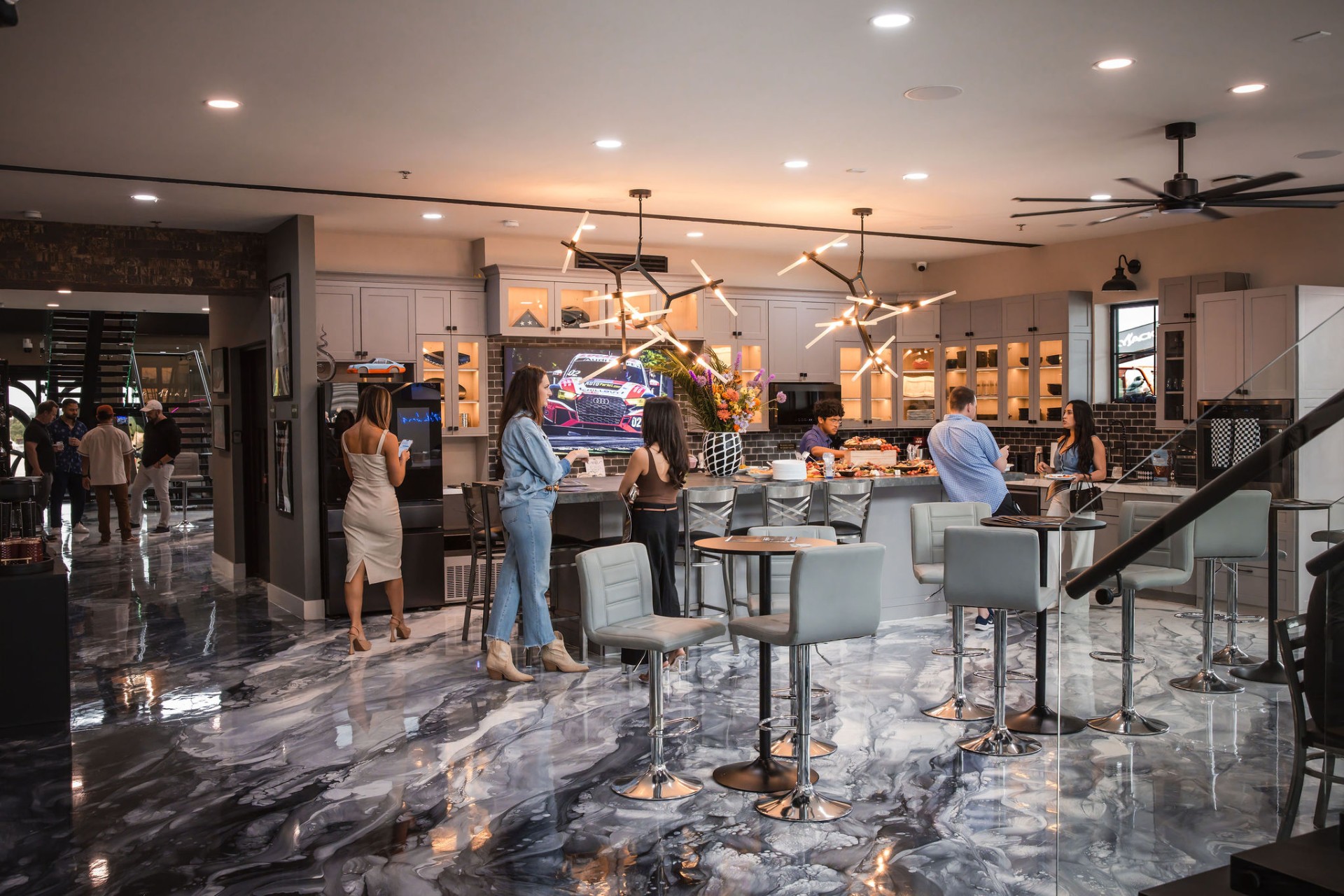 Clubhouse kitchen and bar with owners gathered on epoxy marble floors