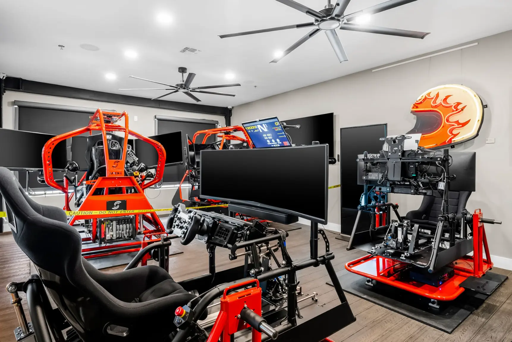 Racing simulator room with motion sim rigs and neon helmet sign