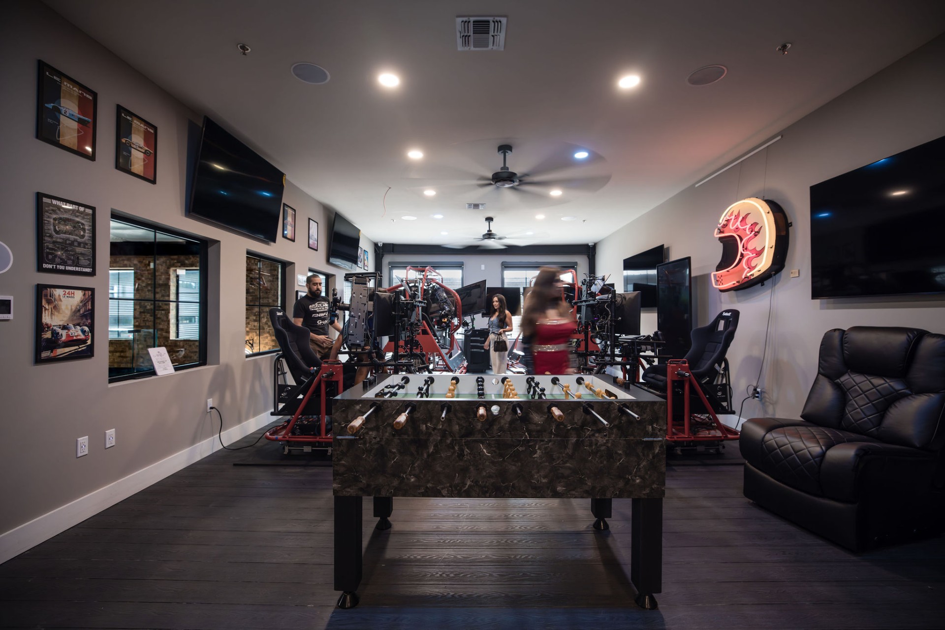 Sim racing lounge with foosball table and Le Mans posters
