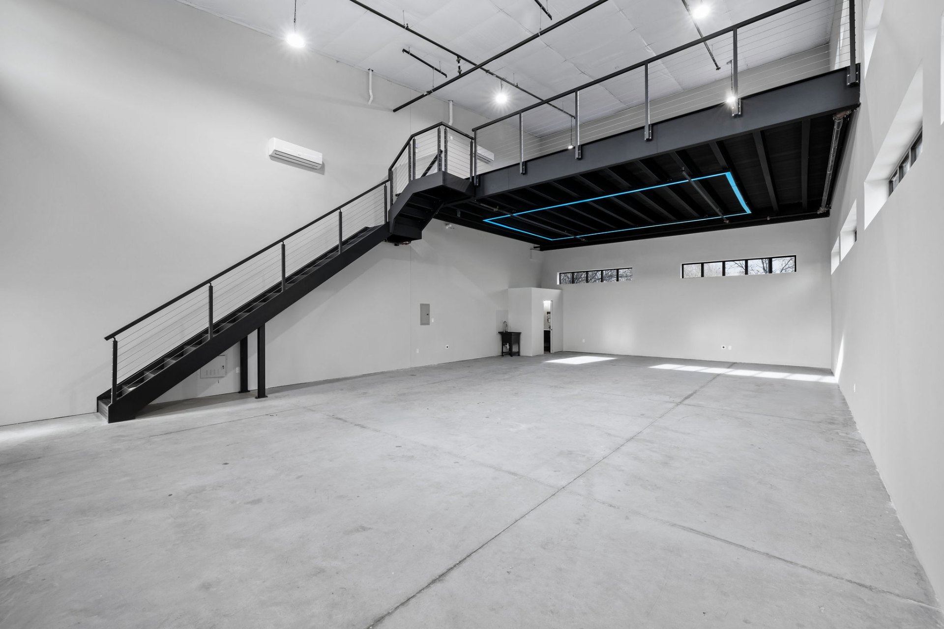 Interior of a GOTA unit with steel staircase and 2nd story mezzanine