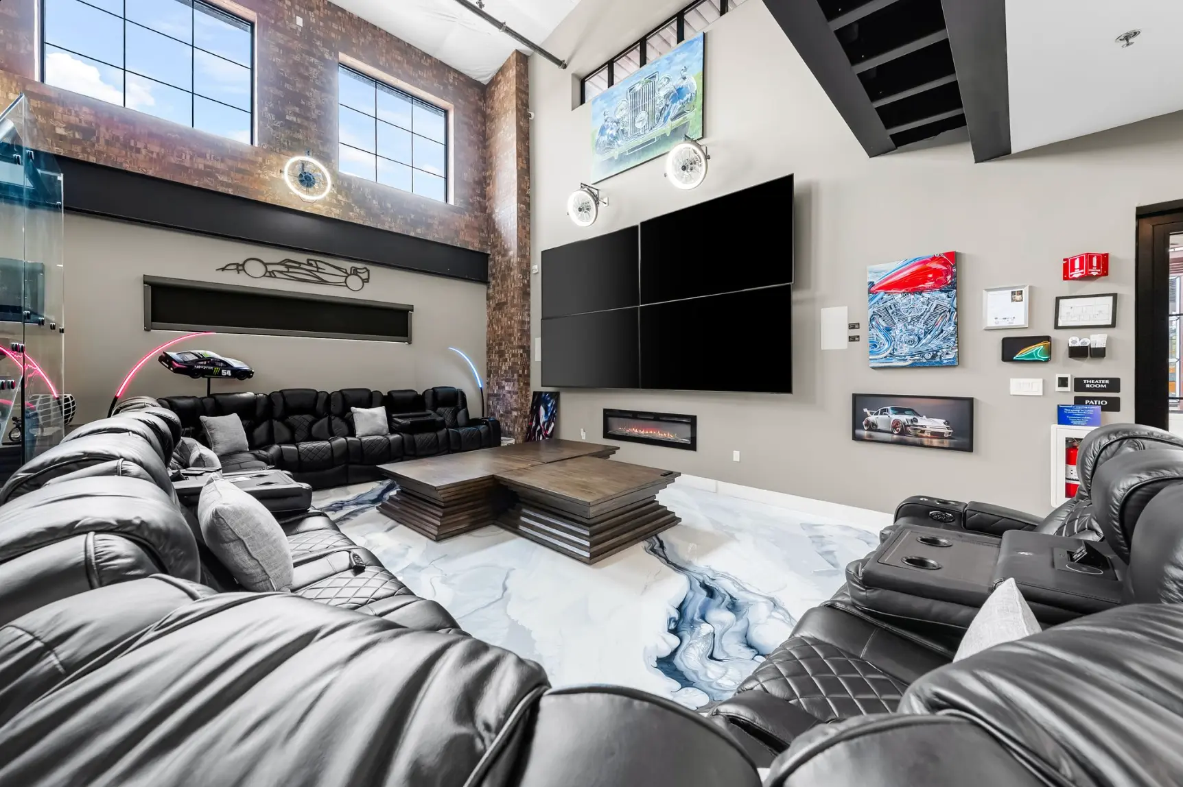 Clubhouse theater room with leather recliners and video wall