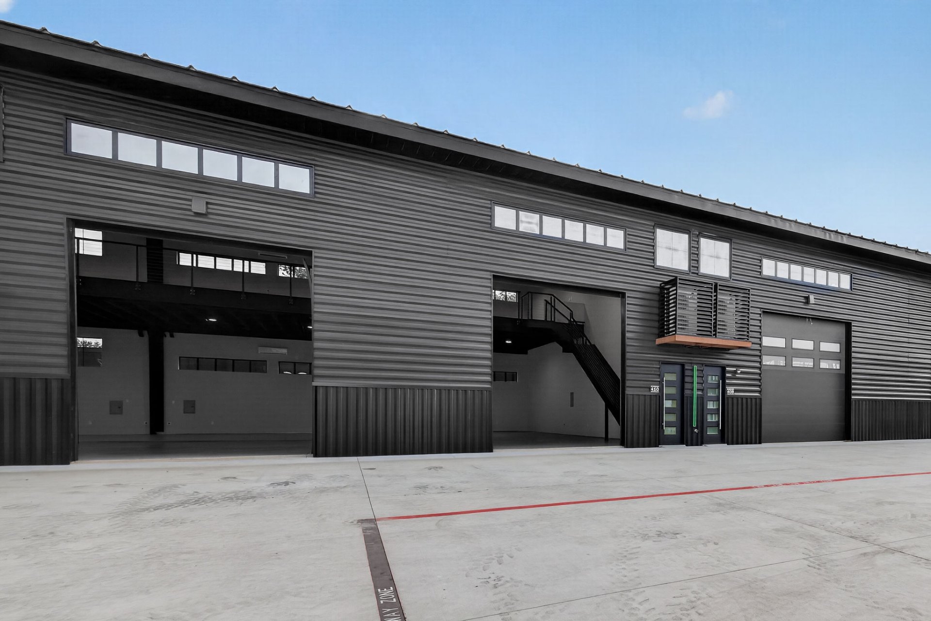 Row of GOTA units with garage doors open showing interiors