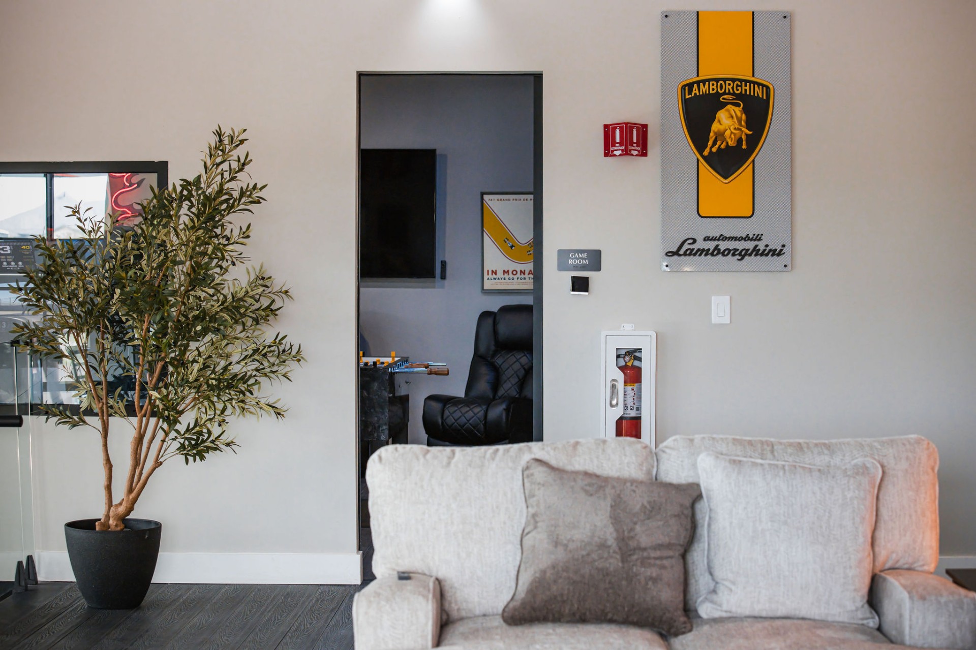 Clubhouse lounge with Lamborghini wall art and Monaco poster