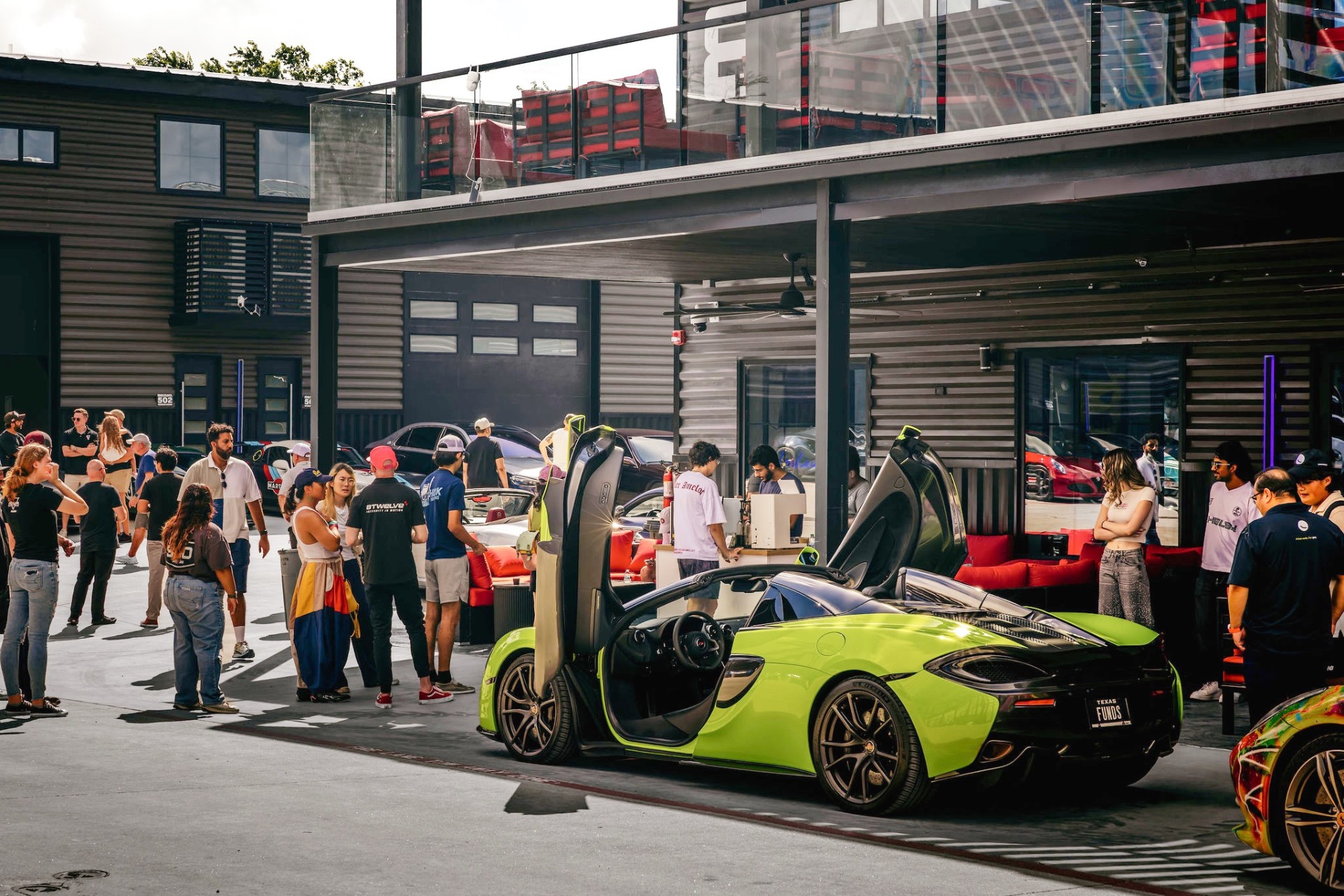 Owners gathering at a GOTA event with a green McLaren on display